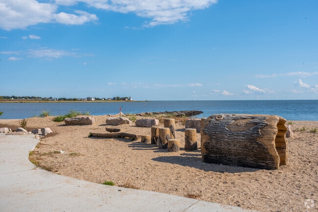 Scenic coastal area in Guilford featuring artistically carved wooden seats.