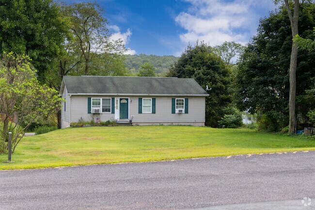 Homes in Dennison commonly feature trees and manicured lawns.