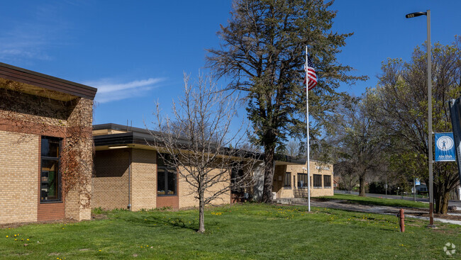 Adams Elementary School is located in a beautiful area full of trees.