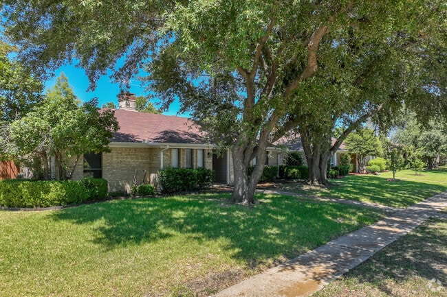 Large trees provide shade to these stunning single story brick homes in Duck Creek.