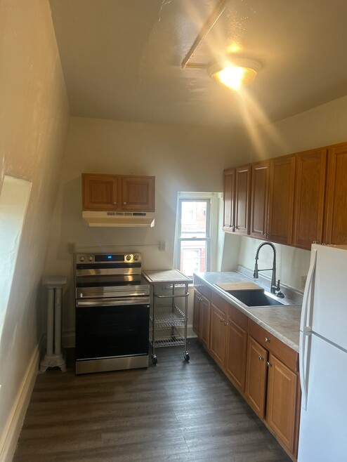 Kitchen with Refrigerator and Stove Top Range
