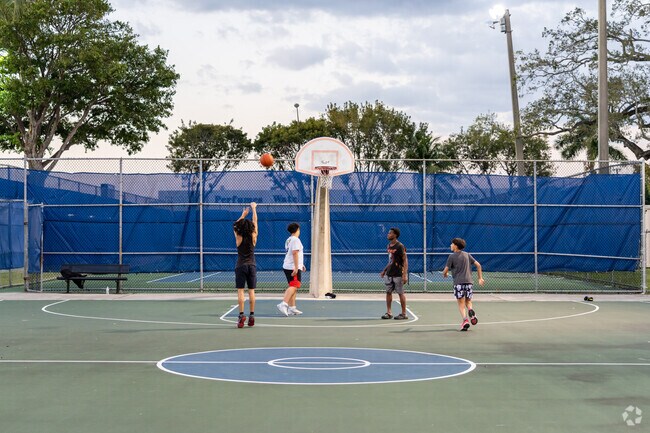 Head to Curtis Park in Allapattah to play pick up basketball.