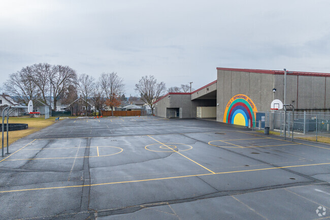 Longfellow Elementary features a basketball court behind the school.