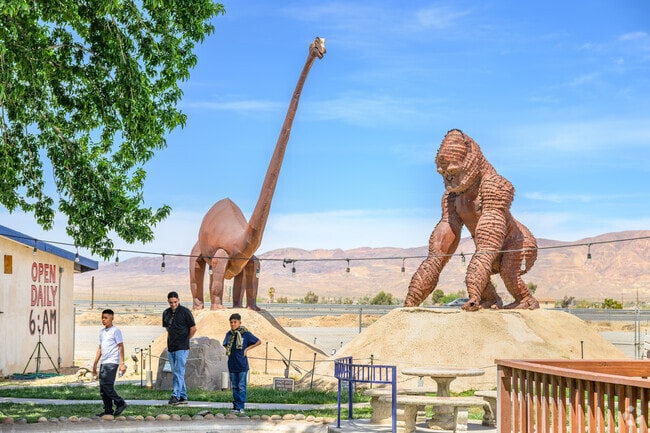 Many tourists passing through Yermo stop to take photos with large metal sculptures.