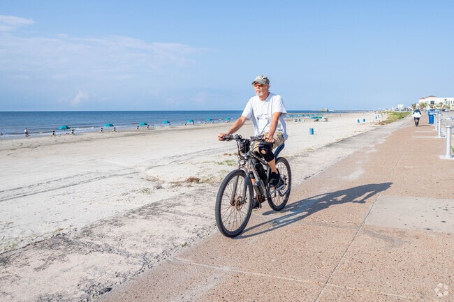 A cyclist enjoys a sunny morning on the famous Galveston seawall, located in Fort Crockett.