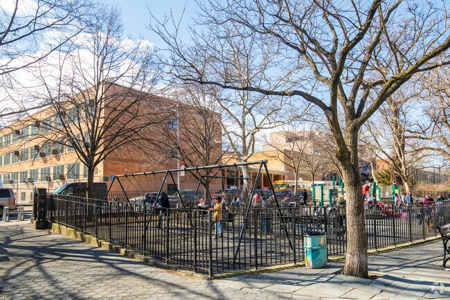 Carroll Park playground area has  a lot of space for children to run around and play.