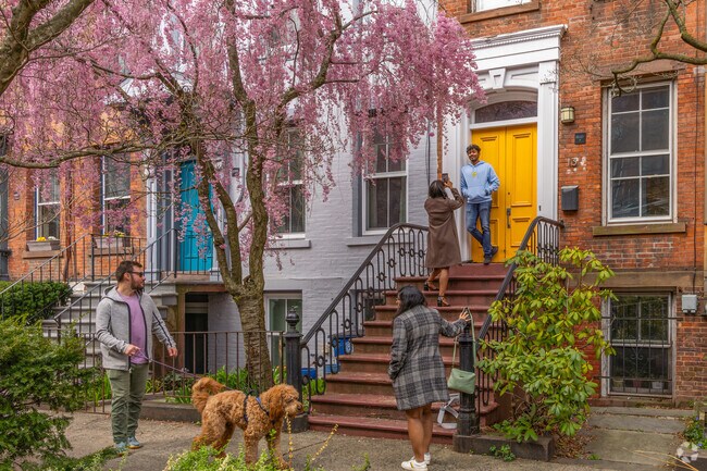 The cherry blossom trees in Wooster Square make a beautiful background for a photo.
