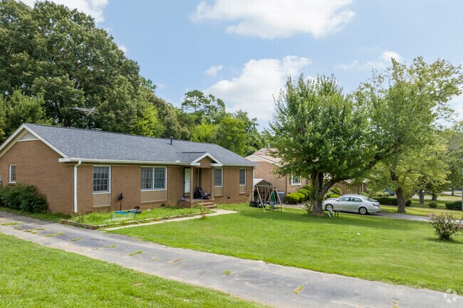 Trimmed yards and old growth trees surround the beautiful Pawtuckett homes.