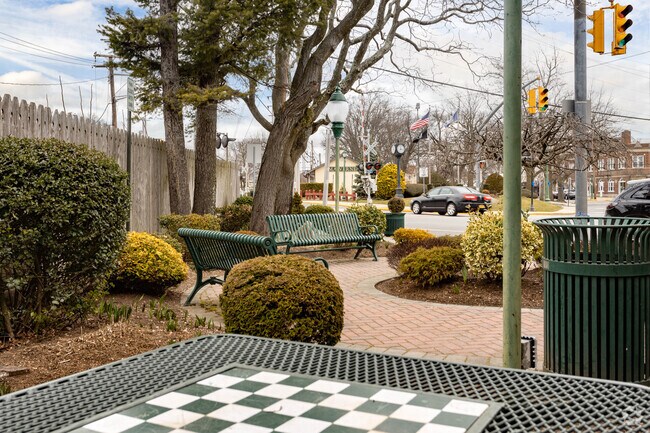 There is a game table and some benches at the Purcell Place Park in Malverne.