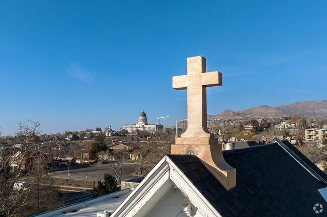 A golden cross tops the pale blue building at The Madeleine Choir School.