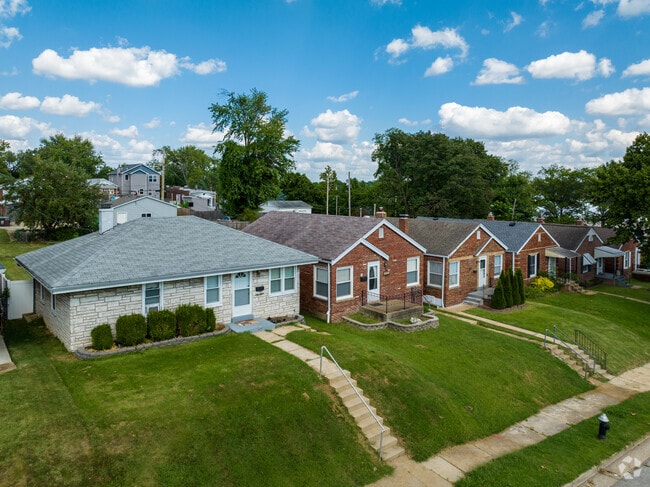 The homes in Boulevard Heights sit snuggly together on grassy lots with large trees.