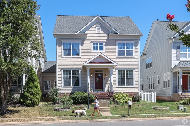Residents enjoy a scenic stroll with their dogs on Kingsbrooke tree-lined sidewalks.