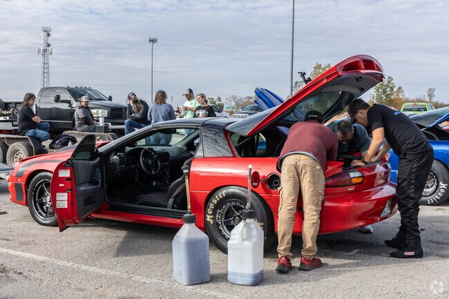 Crews perform final tune-ups and prepare the nitrous tanks at Tulsa Raceway Park