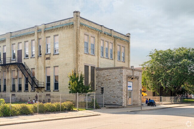 Trees and a playscape sit out the St. John Nepomuk Elementary School in Racine, WI.