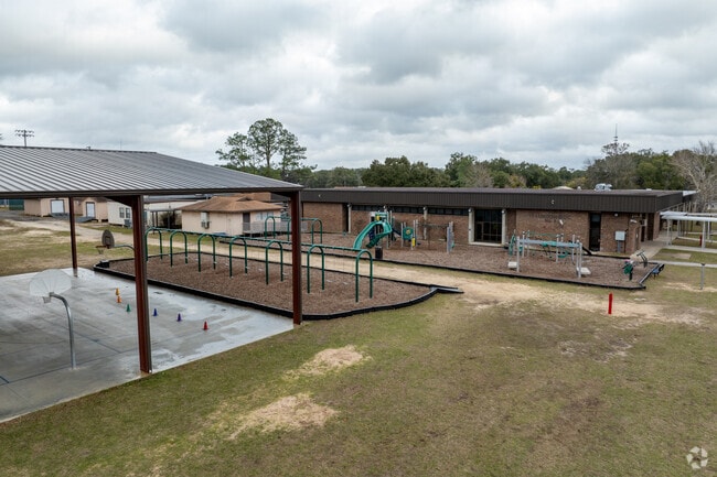 Local children enjoy the basketball court and swings at Keystone Heights Elementary School.