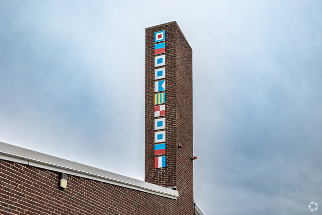 Colorful flags decorate a chimney at Wessagusset Elementary School in Weymouth.