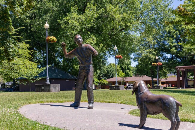 A statue of a boy and his dog represent the very active neighborhood of Broadway.