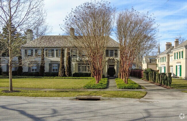 Trees line the long sidewalk leading to this home in the Guilford neighborhood.