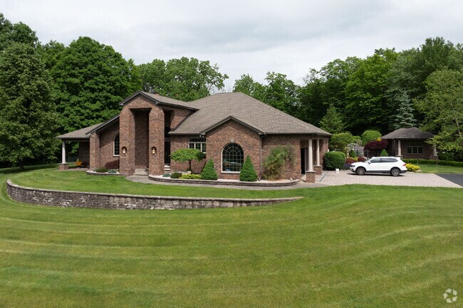 A striking brick modernist home sits on a large lot in North Greenbush.