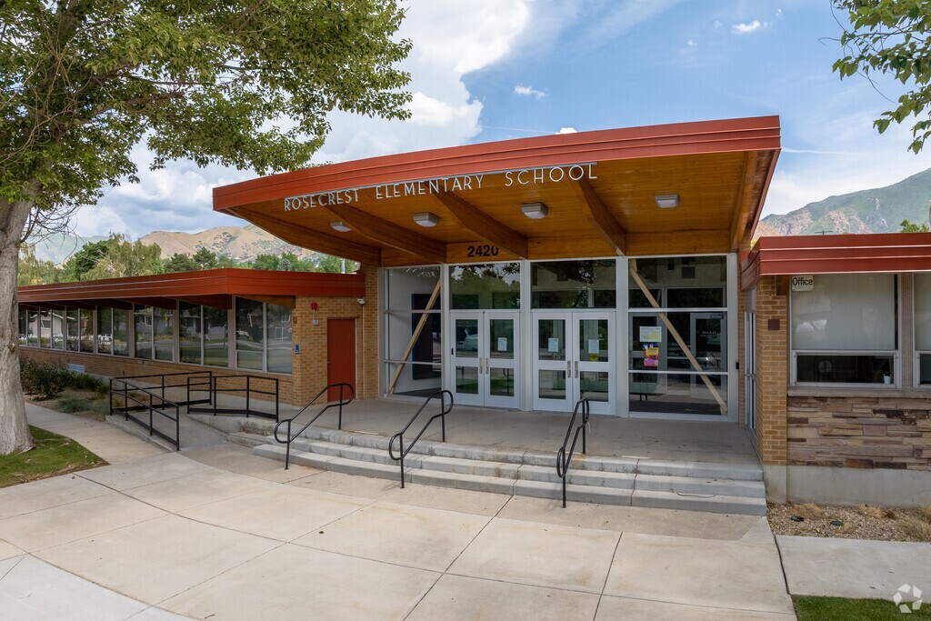 Red details over wood and glass at the front entrance of Rosecrest Elementary School.