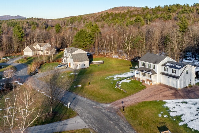 A quiet Westford neighborhood sits at the edge of the woods, with well-kept homes, open lawns, and mountain views that give the area its peaceful Vermont character.