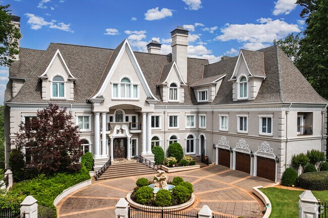 Huntcliff exemplifies luxury architecture with stately estates, manicured lawns, and expansive driveways nestled among forested lots.