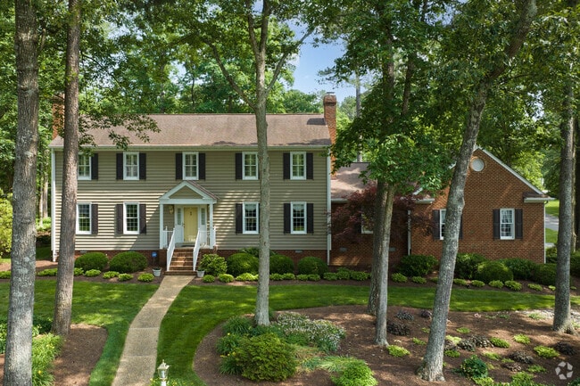 Gayton charming home nestled between tall, mature trees.