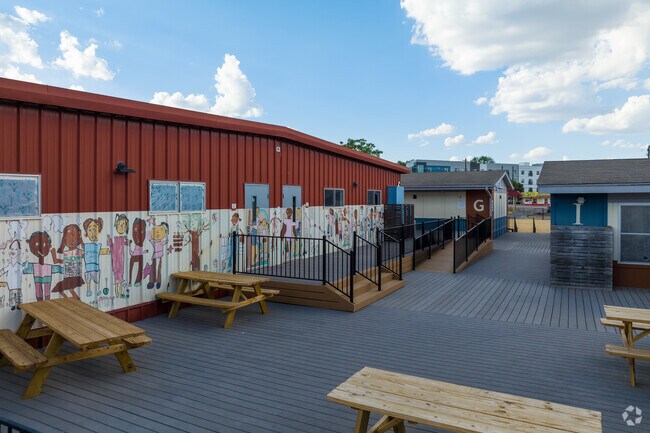 Murals are depicted alongside the building of University of Texas Elementary School in Holly.