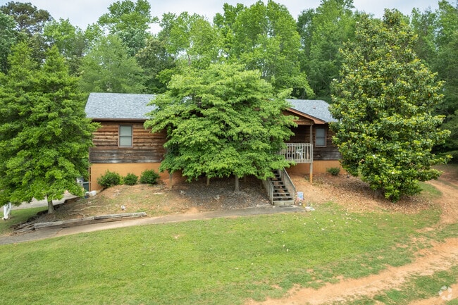 Log Cabins and Farmhouses sit on large plots of land in Bostic.