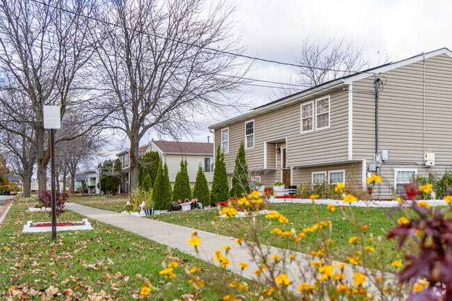 Pine Trails Estates homes feature spacious lawns with flowers..