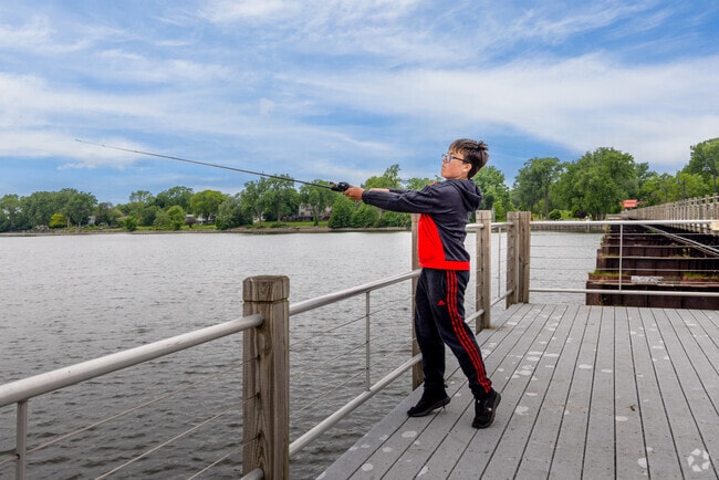 A young angler casts into Little Lake Butte des Morts, enjoying the serenity of Fox Crossing.
