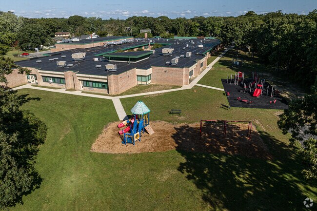 A portion of the filed with the playground.