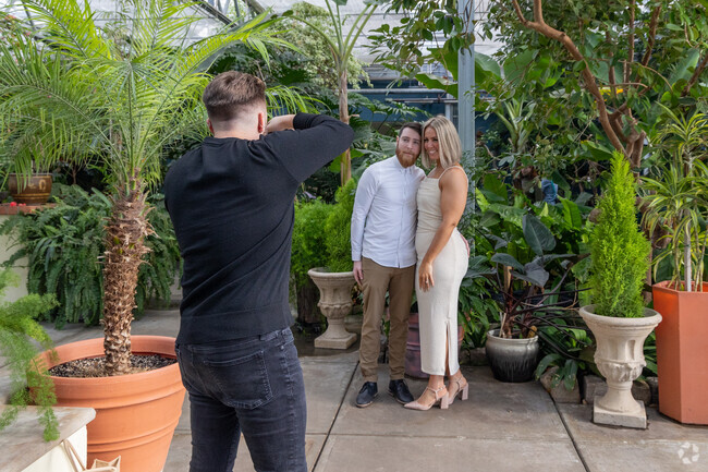 A couple takes engagement photos at the Roger Williams Park Botanical Center in Elmwood.