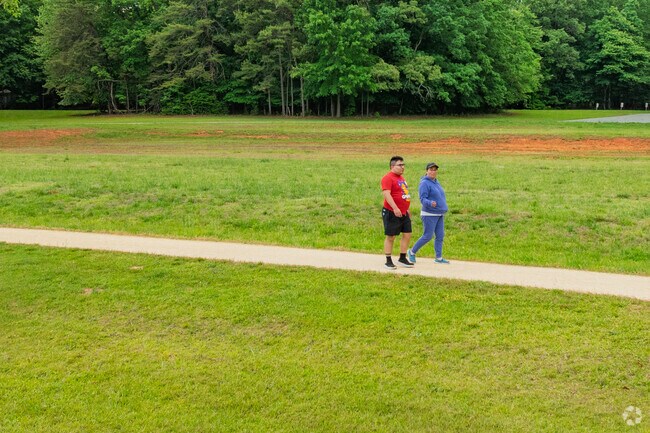 Residents take a peaceful stroll along a greenway trail in Liberty, NC.
