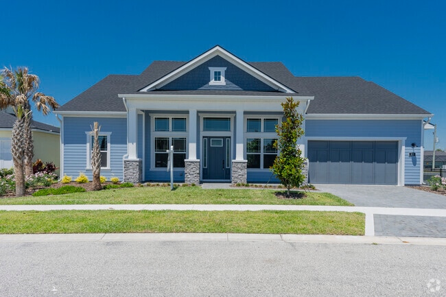 This new construction Ormond by the Sea home has an inviting front porch and crisp landscaping.