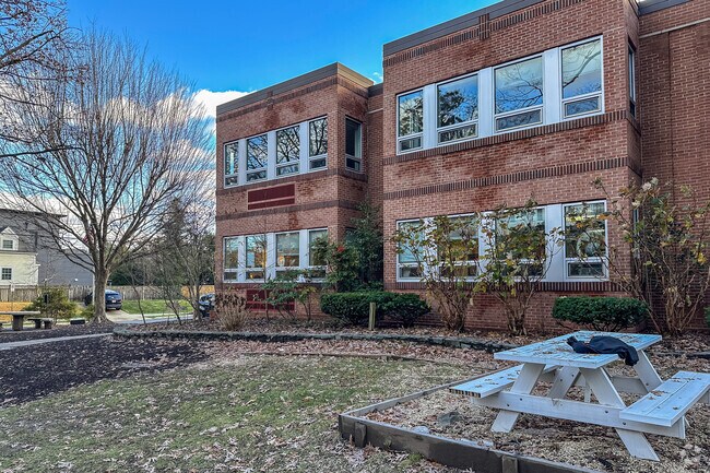 Grass area and bench on the side of Sheridan School