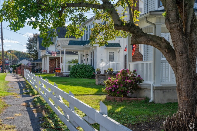 White picket fences align with nice sized yards in front of porches in Avoca.