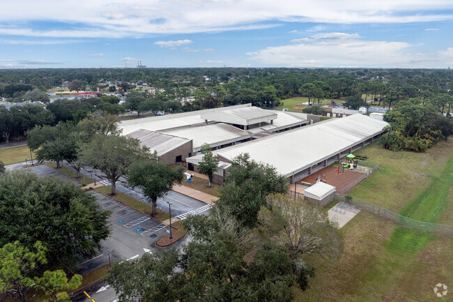 mature tree provide privacy for Challenger 7 Elementary School.