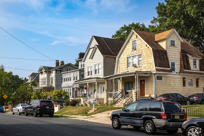 Colonial and Dutch-Colonial single family homes sit together on this street in Bayway, NJ.