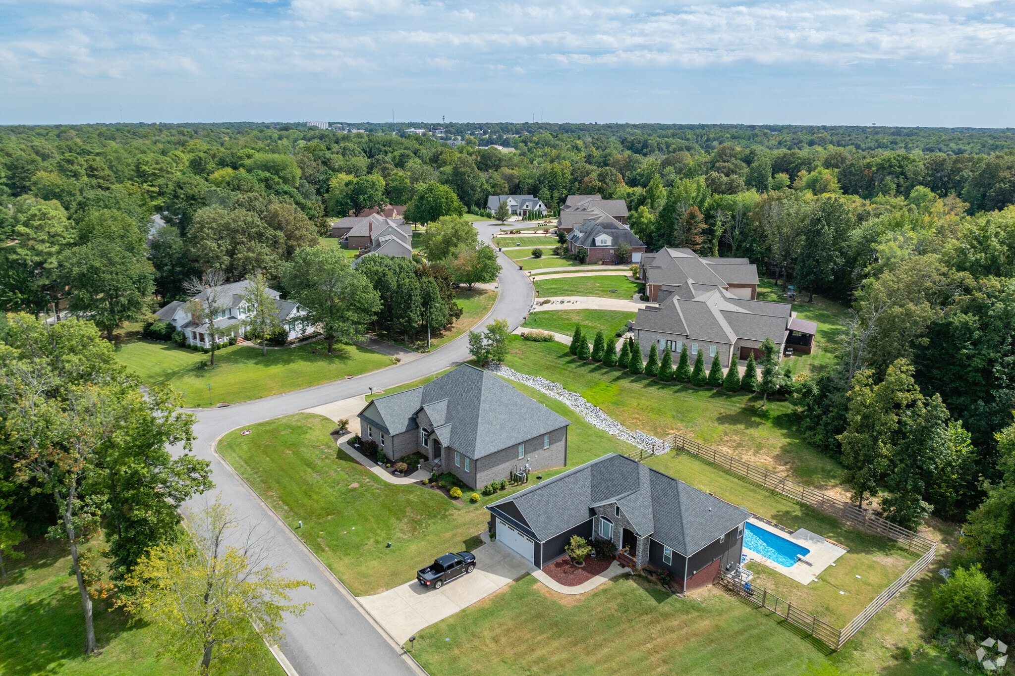 The Fairfield neighborhood has wooded lots full of lush green trees.