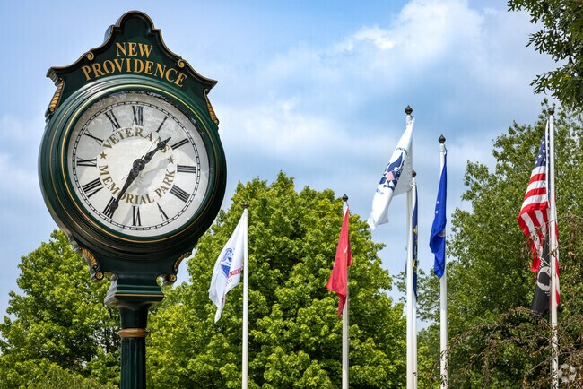 A town clock and flags at Veterans Memorial Park located in New Providence, NJ.