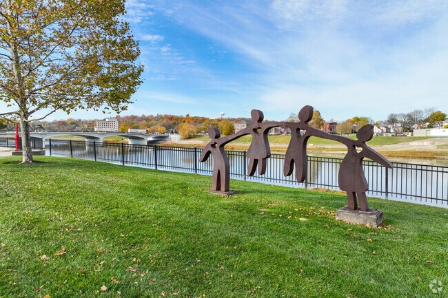 Joyful artwork stands by the Great Miami River front in East Hamilton.
