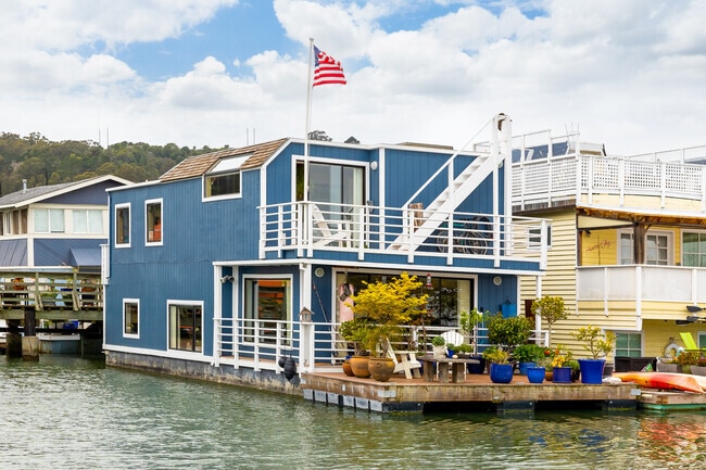 A blue Sausalito boathouse floats in the bay.