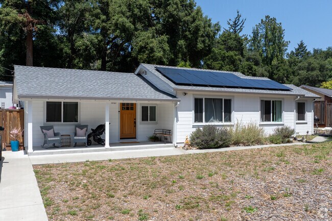 This refreshed Ranch-style home in Ben Lomond features crisp white siding, a welcoming front porch, and simple landscaping that complements its peaceful mountain setting.