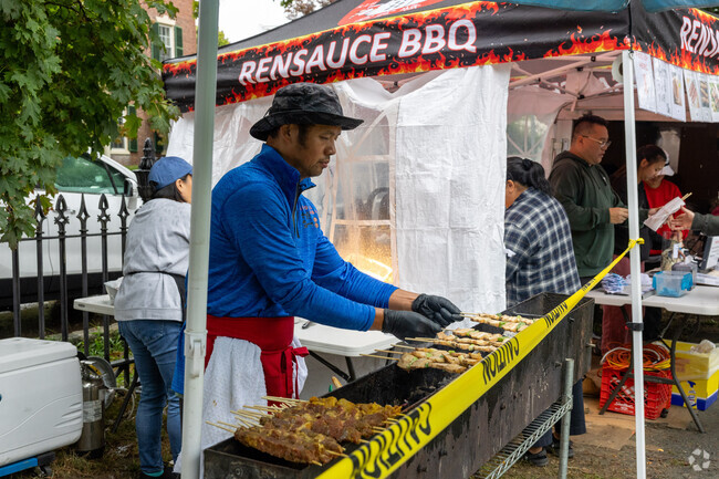Rensauce BBQ cooks skewers over hot coals at the Salem Food Truck Festival.