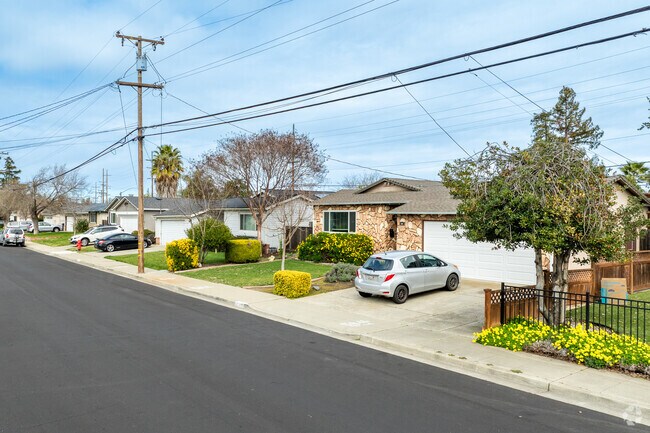 Classic Sunset West charm shines in this well-kept home with a stone façade and lush landscaping.