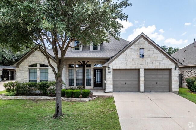 This larger, more modern, ranch style home has a peaked roof and 2-car garage in Cedar Park Ranchettes.