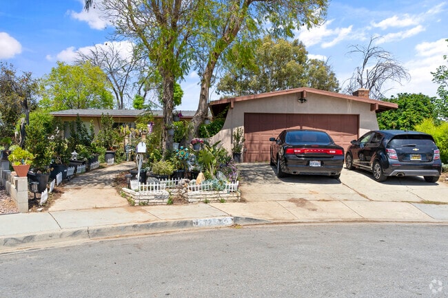 Discover charming Menifee homes with lush front yard gardens.