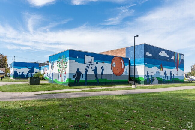 Neighbors in Miller Grove admire the colorful exterior of the Crowell Recreation Center.