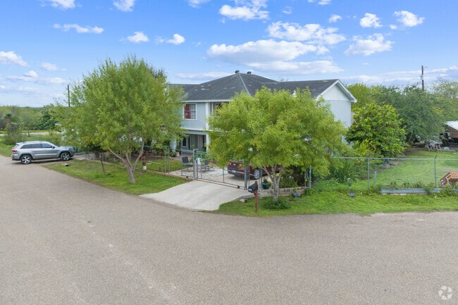 Two-story homes in this part of town are shaded by many trees.